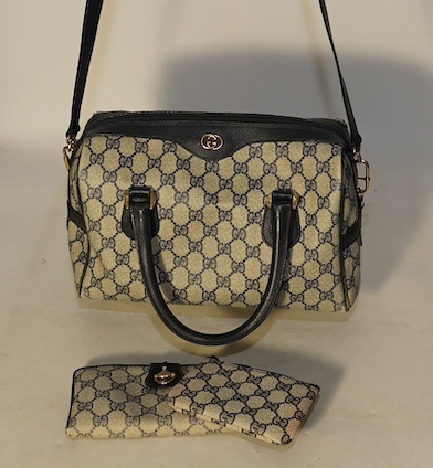 A Gucci monogram blue canvas handbag, wallet and purse